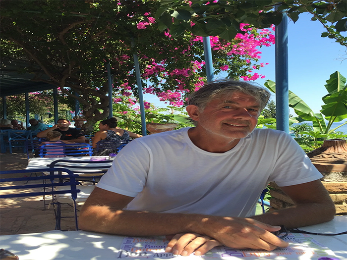 Greg Berryman sitting at a taverna on Corfu